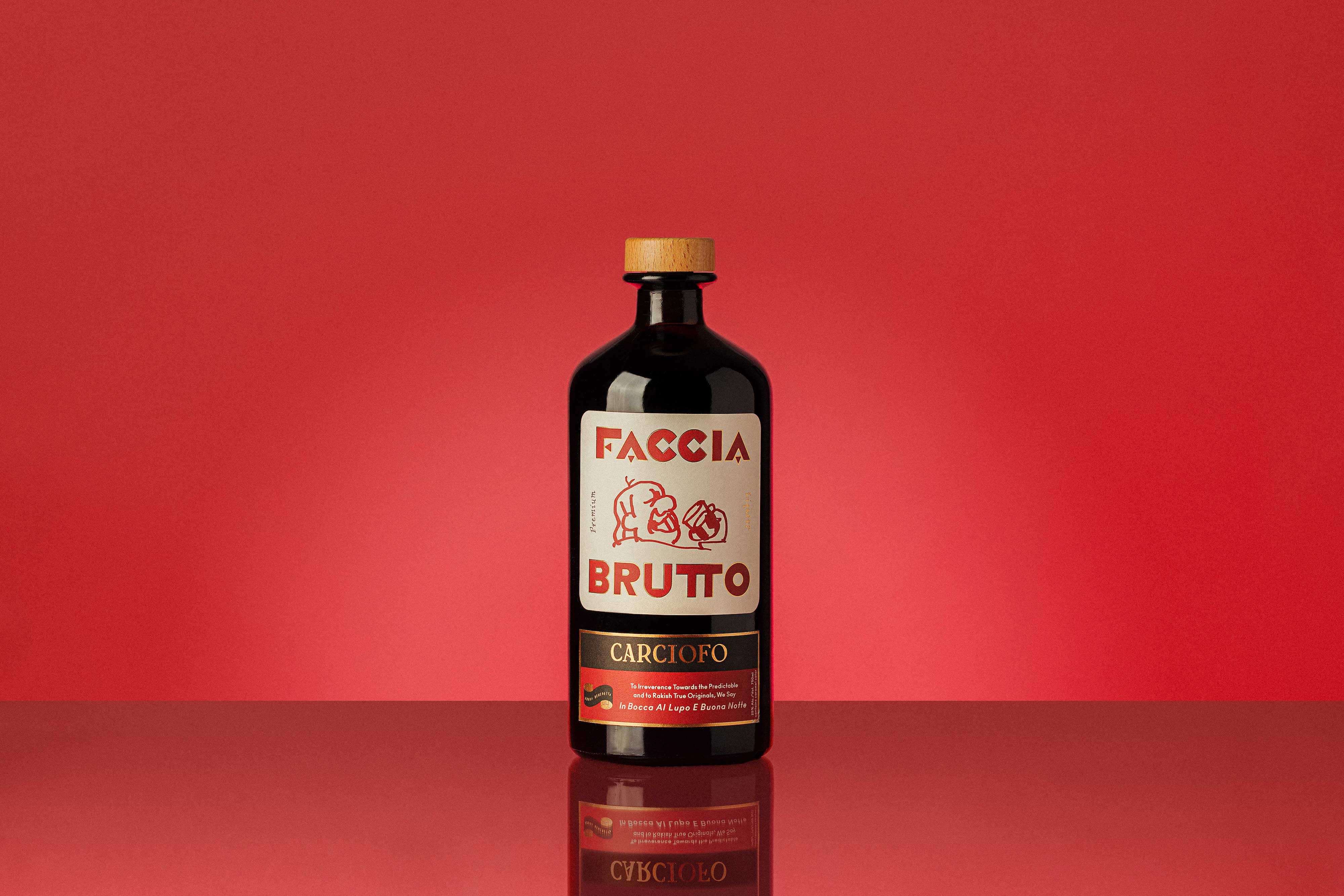Wide shot of front of Faccia Brutto Carciofo bottle with red background